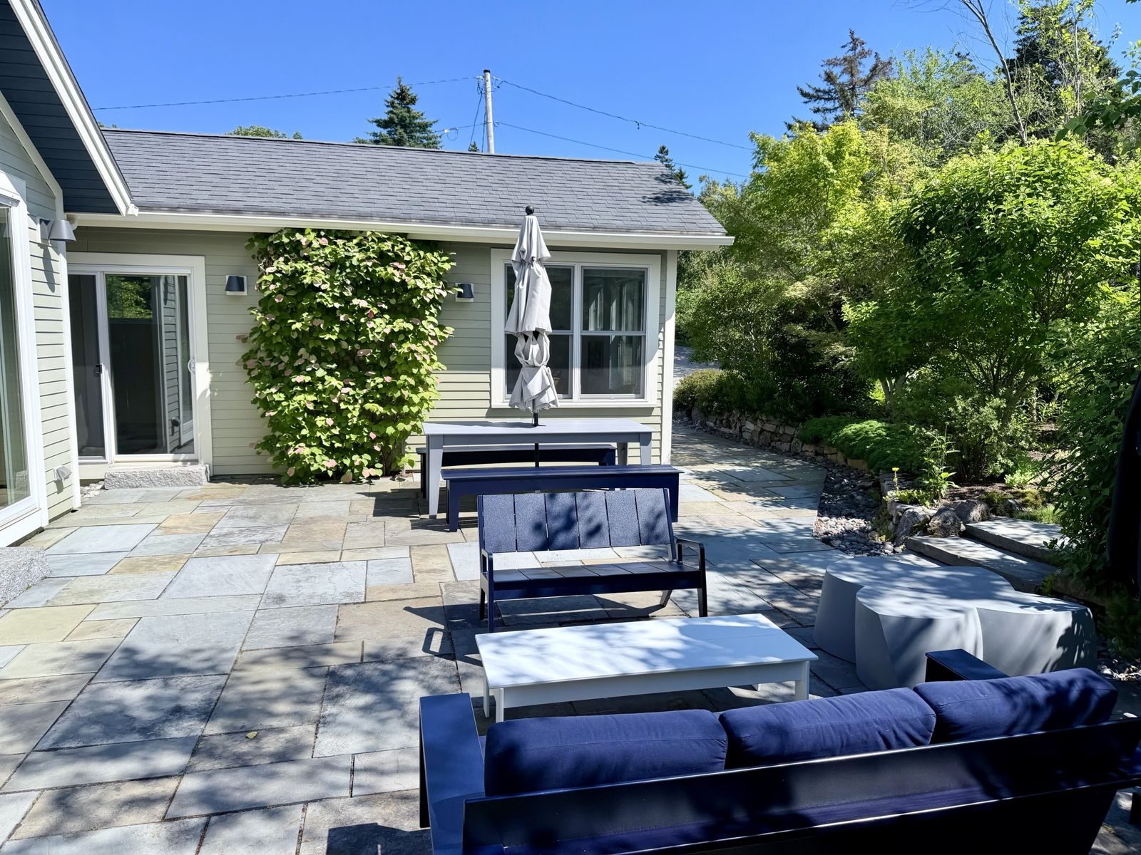 Bluestone terrace with outdoor sofa and dining table