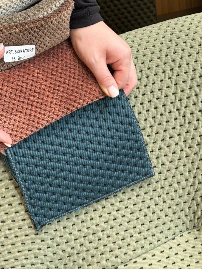 Teal and rust woven swatches on a green sofa