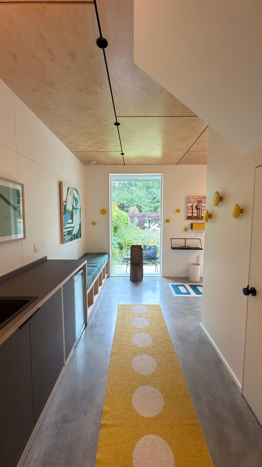 Entry hall with yellow runner and garden window