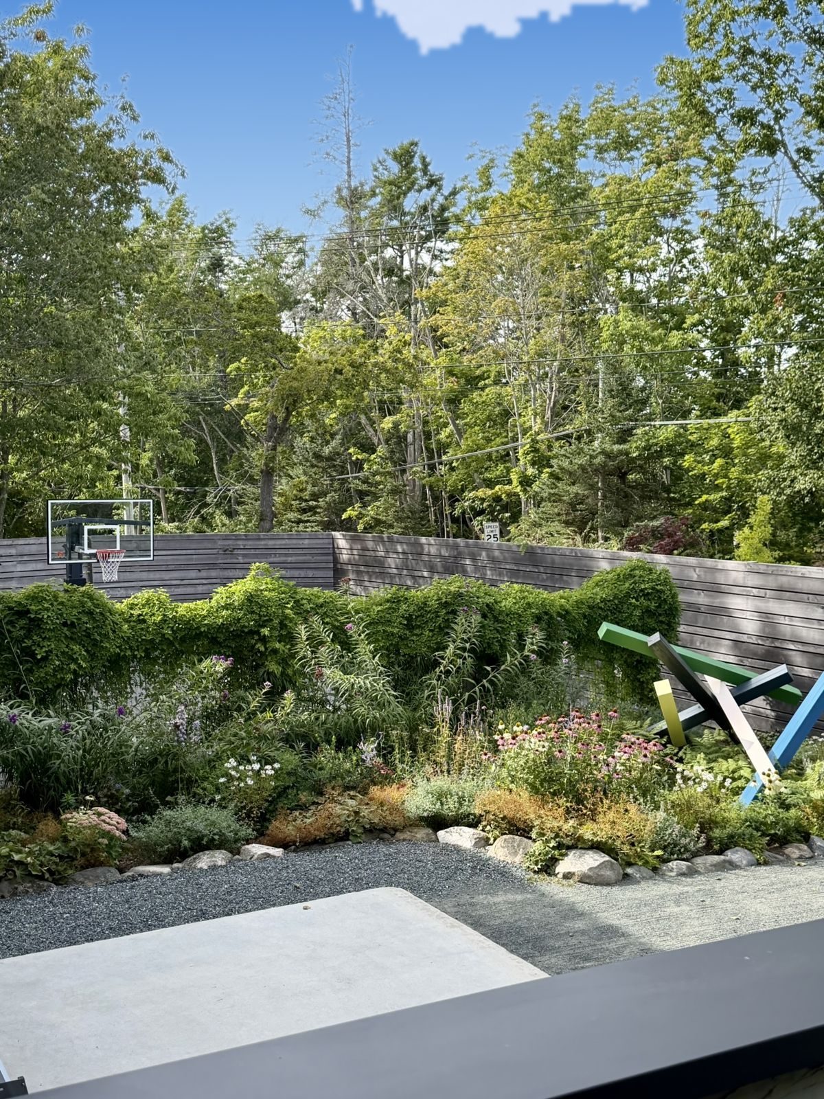 Basketball half-court, perennials and a painted sculpture
