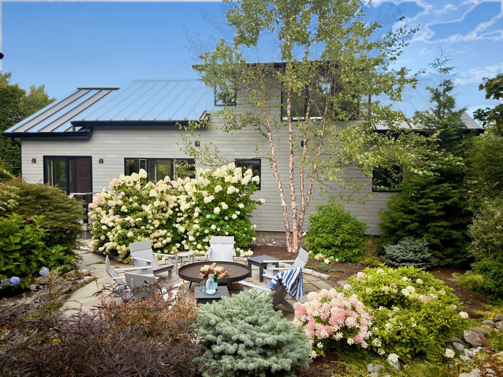 Back of the Schoolhouse: fire pit, river birch and hydrangeas