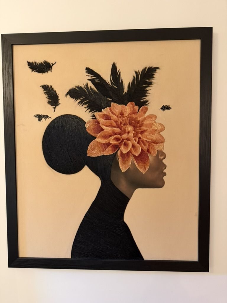 Embroidered portrait with a coral dahlia