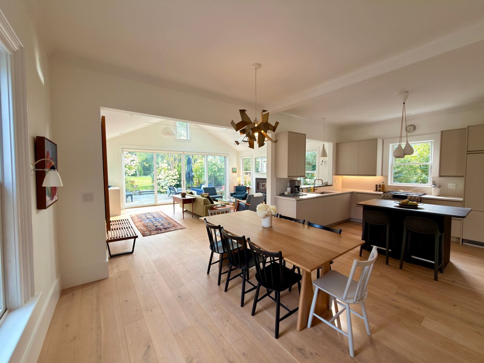 Dining table and kitchen open to the sunroom