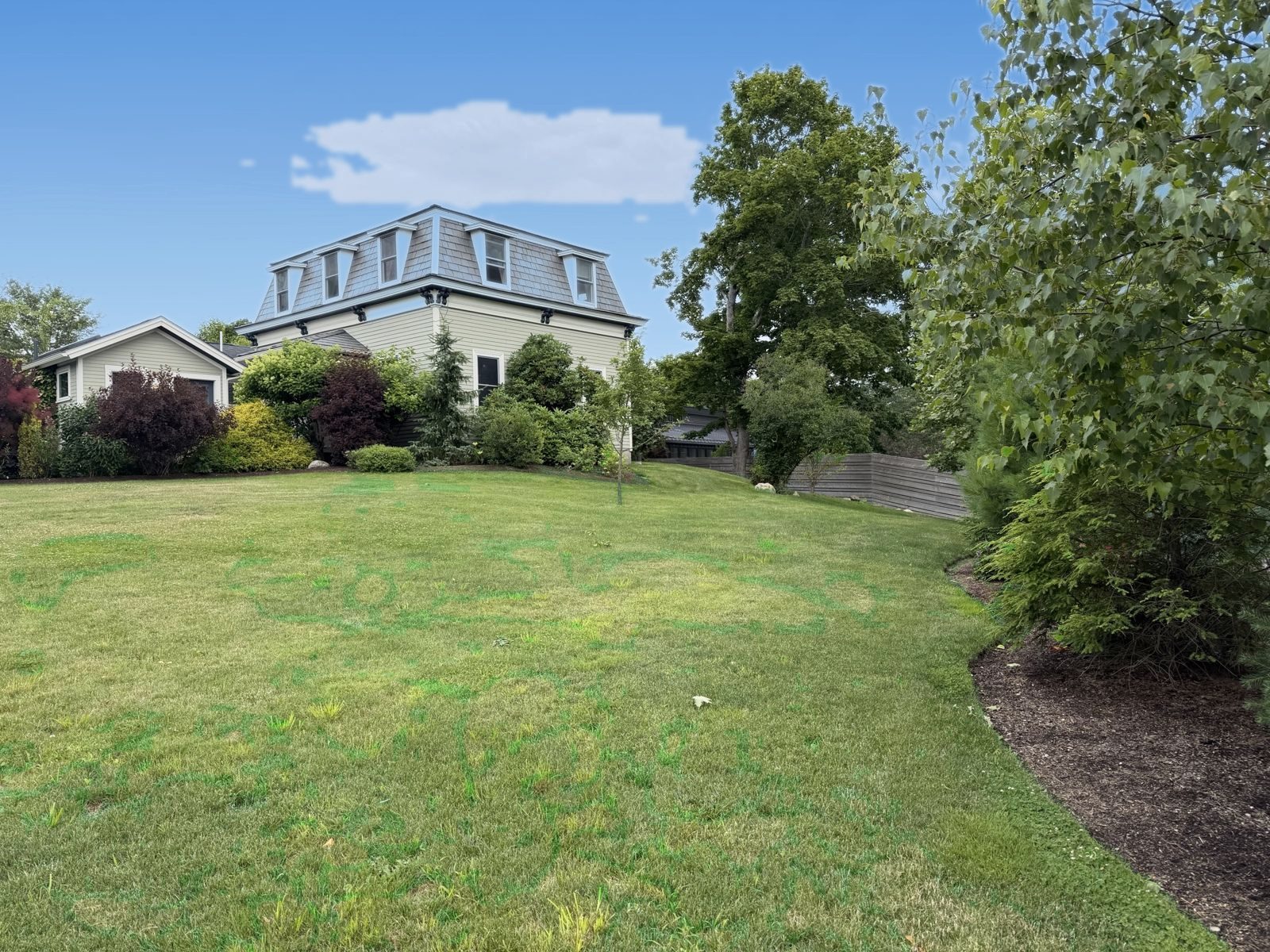 Wide lawn sweeping up to the Mansard
