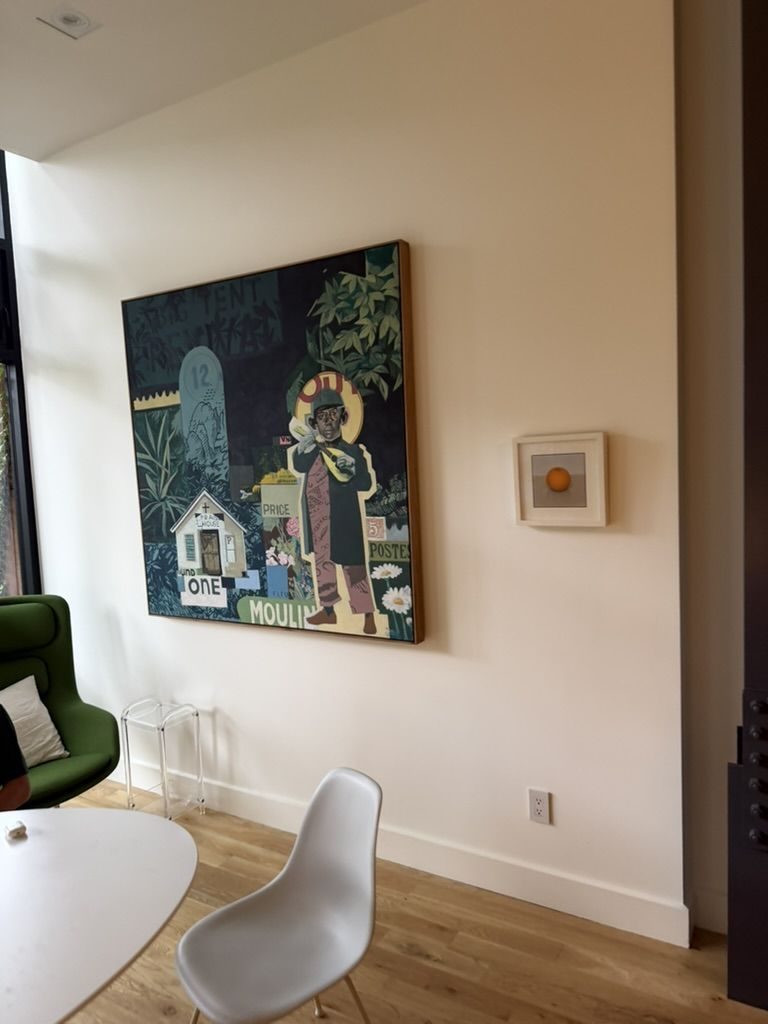 Large collage painting in a sunny room